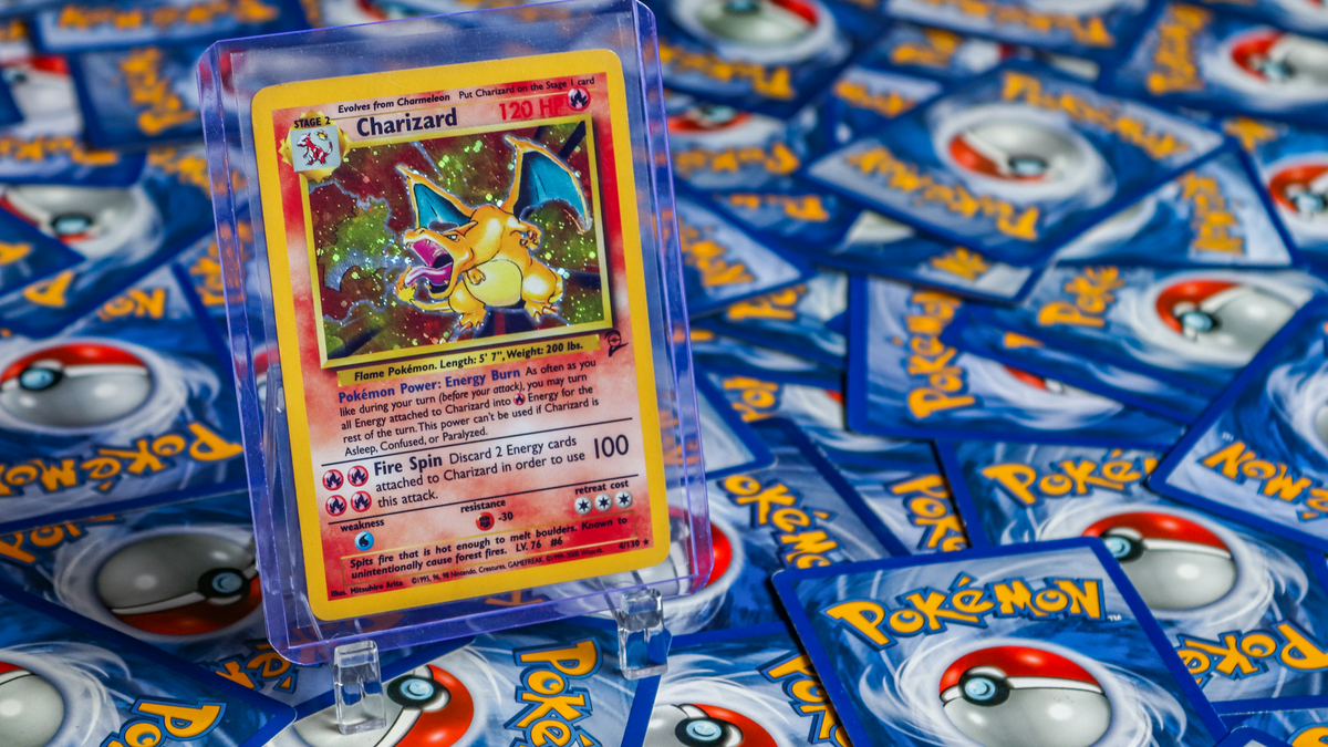 Rare Charizard Pokémon card displayed on a pile of Pokémon cards