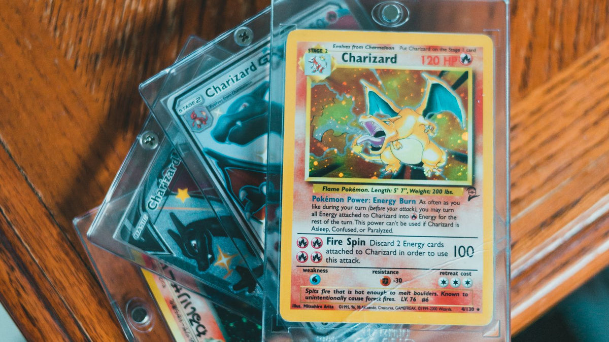 Graded Pokémon cards in protective cases on a wooden table